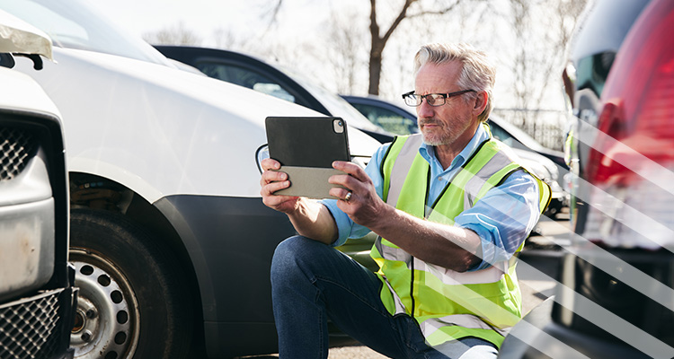 man inspecting car